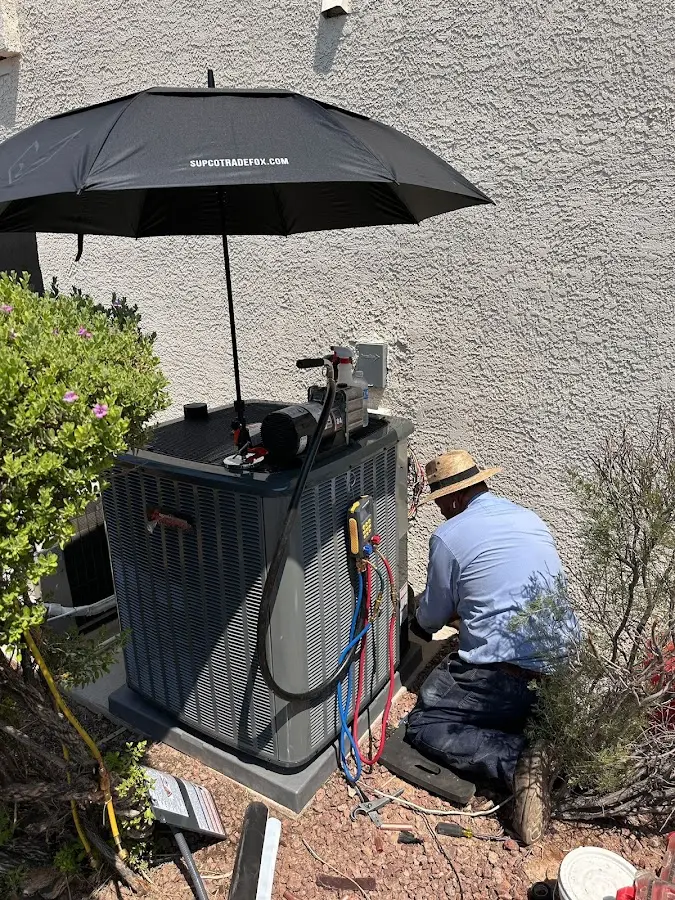 HVAC technician performing outdoor AC maintenance in Morton